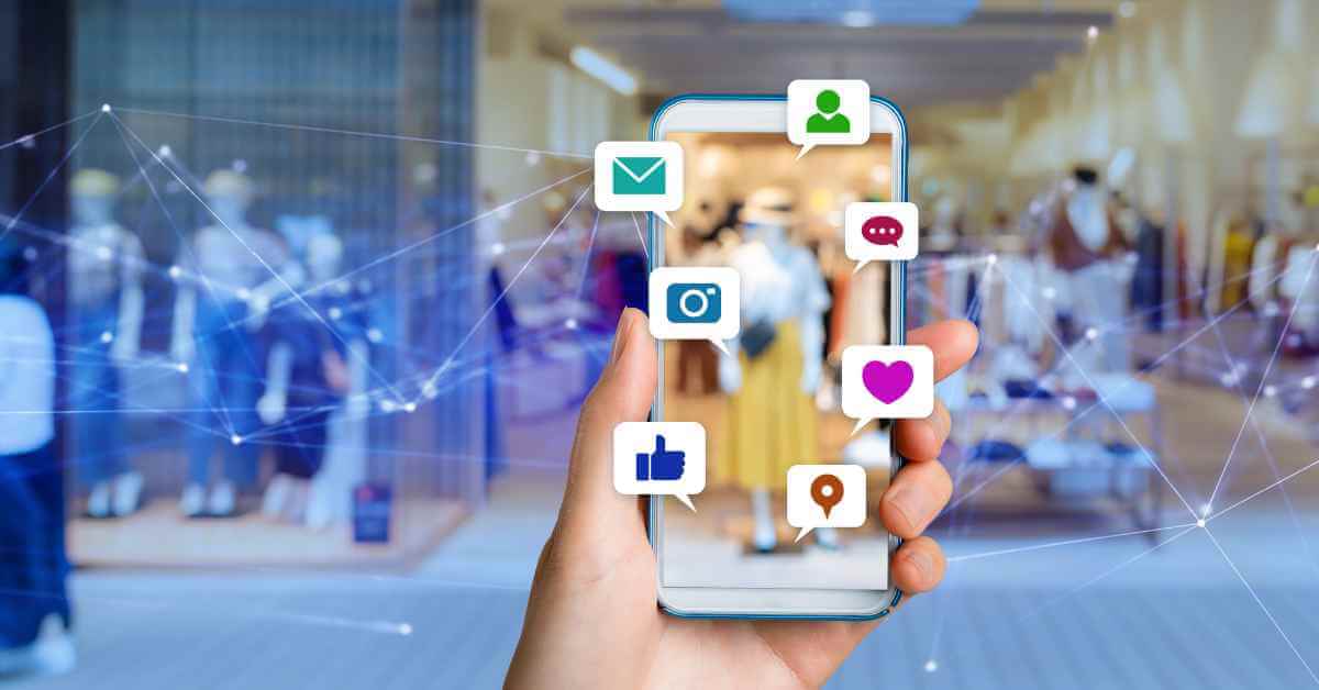 A hand holding a smartphone with multiple social media apps