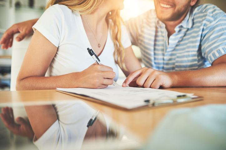 happy couple signing a contract