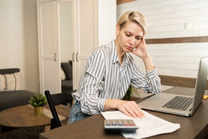 stressed woman calculating finances